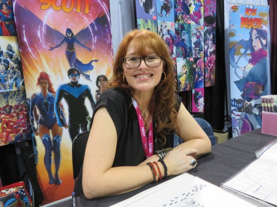Nicola Scott at her Artists Alley booth, but at an angle that shows other booths instead of her own. Our bad.