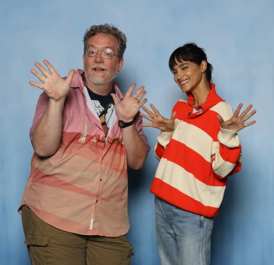 Me doing jazz hands with Sofia Boutella, who's wearing jeans and an orange-and-white striped sweater.