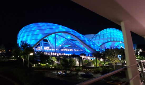 Neon blue peanut-shaped building at night. But it's an cool-looking blue peanut.