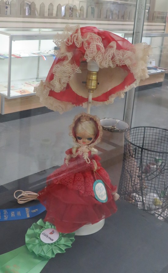ugly lamp contest winner, girl in red dress with evil shadowed eyes.