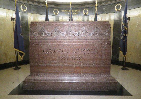 Head-on view of the Lincoln monument in the main burial room. Six feet tall, several feet wide, rectangular, brownish-red, same details as our lead photo.