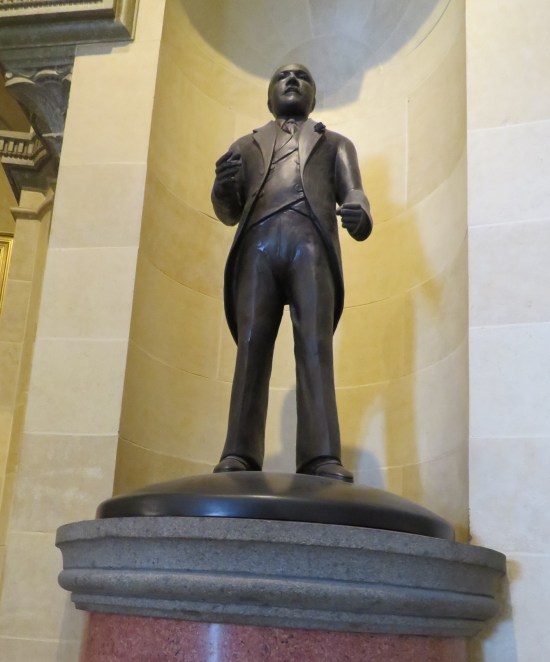 Statue of Adelbert Roberts in a long suit coat.