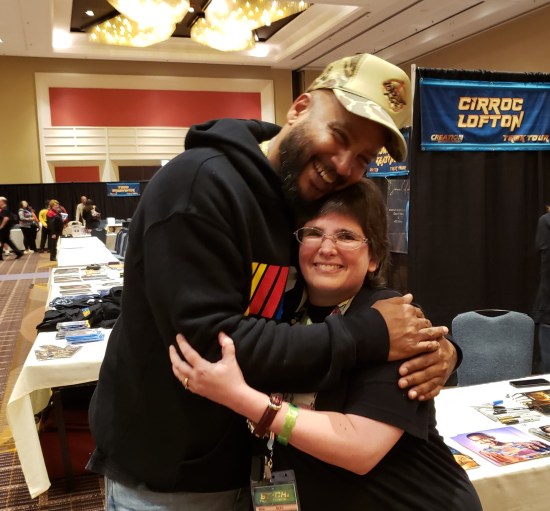 Cirroc Lofton bending down to hug Anne.