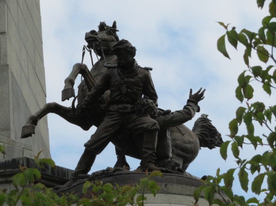 Statues of Civil War soldiers wrestling next to a bucking horse.