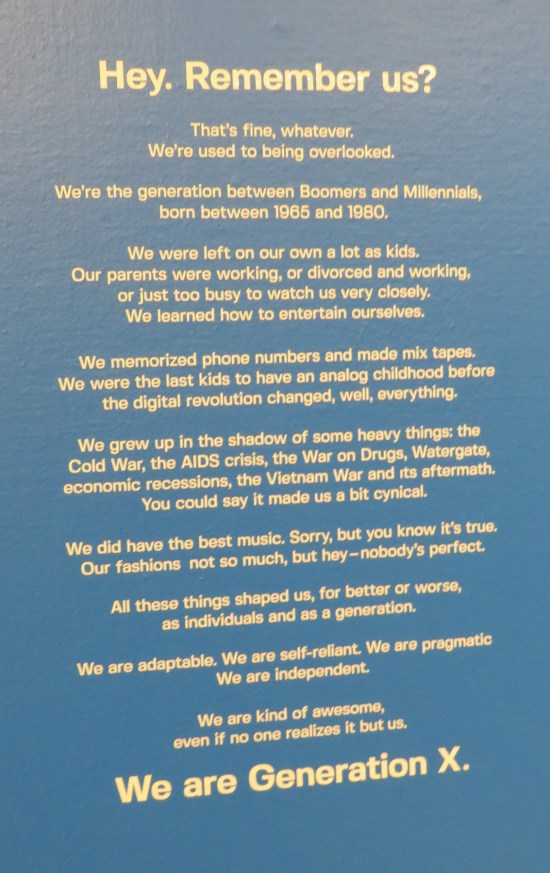 Long intro to the exhibit written in white typeset on a blue wall, too long to transcribe here. 