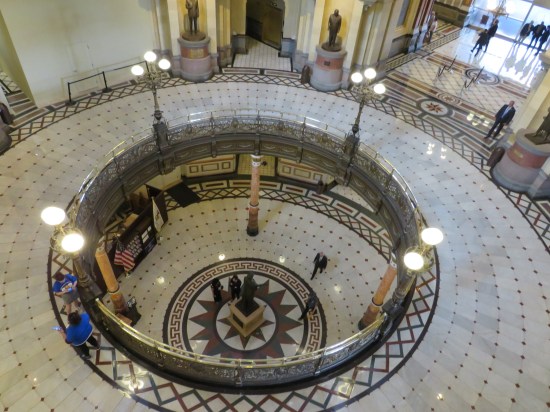 Viewpoint from the third floor of the rotunda, looking down on the first two floors. Other tourists and politicians mill about.
