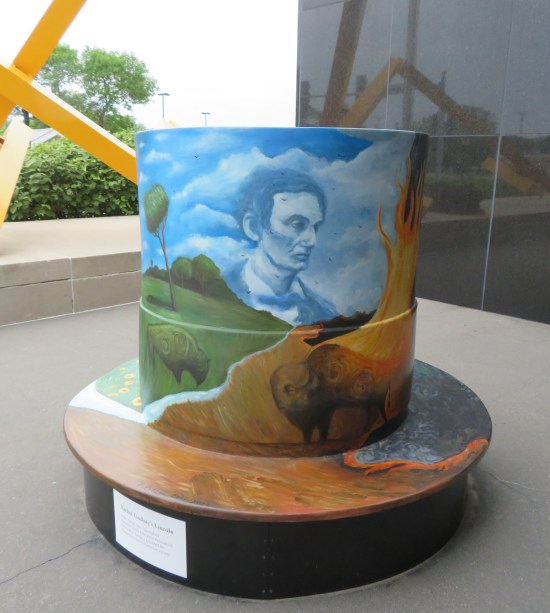 5-foot-tall top hat with a landscape of bison and a cloudy sky with the ghostly visage of young Abraham Lincoln.