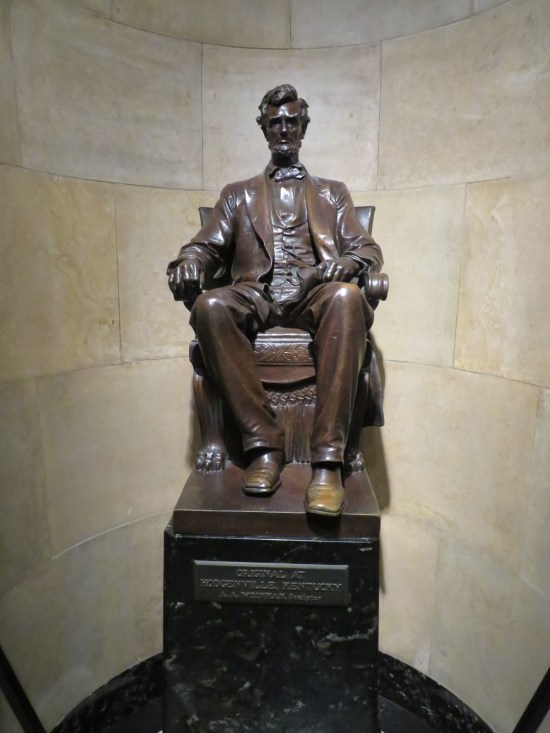 Statue of Lincoln sitting in a chair with good posture.