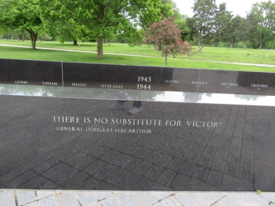 Short black marble wall engraved with MacArthur quote: "There is no substitute for victory."