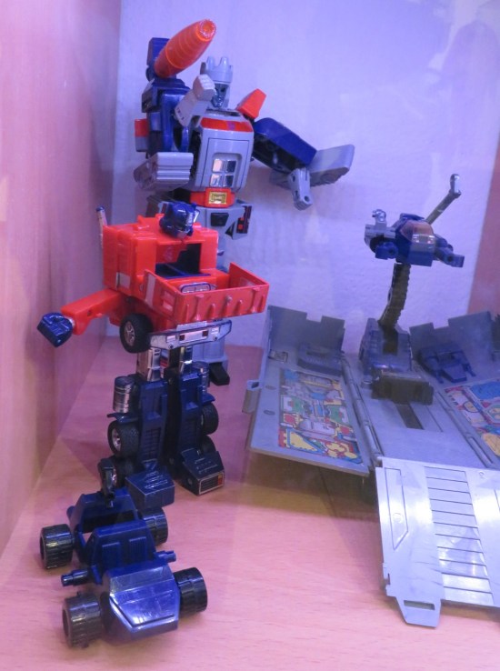 Display of Optimus Prime, his trailer, his tiny car, and some old airplane guy I don't recognize.