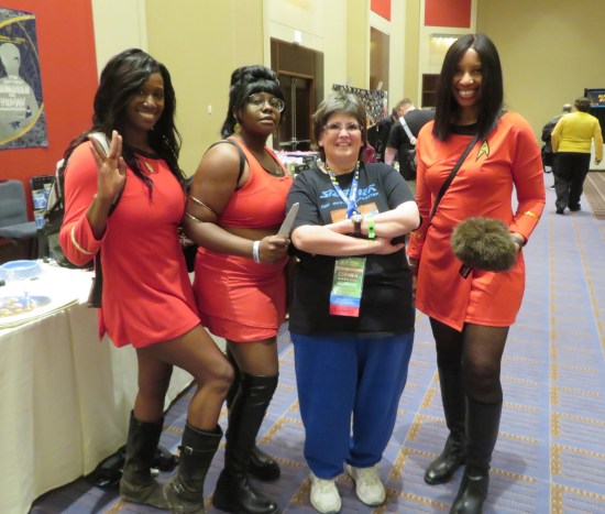 Anne posing with three different Uhura cosplayers.