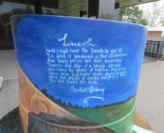 5-foot-tall top hat decorated in slight homage to Van Gogh's "Starry Night" except the stars are replaced with a single poem in white letters.