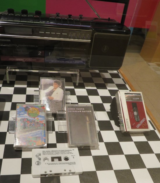 A Walkman, a boom box, and four cassettes: Michael Jackson's "Thriller", Sonic Youth's "Daydream Nation", Prince and the Revolution's "Around the World in a Day", and Rick Astley's "Whenever You Need Somebody" without the case.