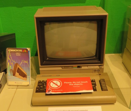 An ugly green Commodore 64 monitor, keyboard, and User's Guide.