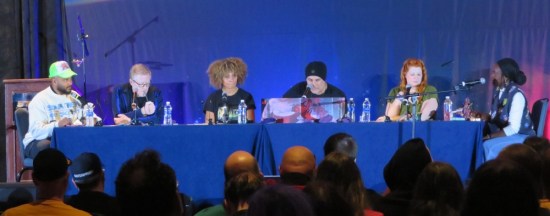Six Trek actors sitting at one long table onstage.