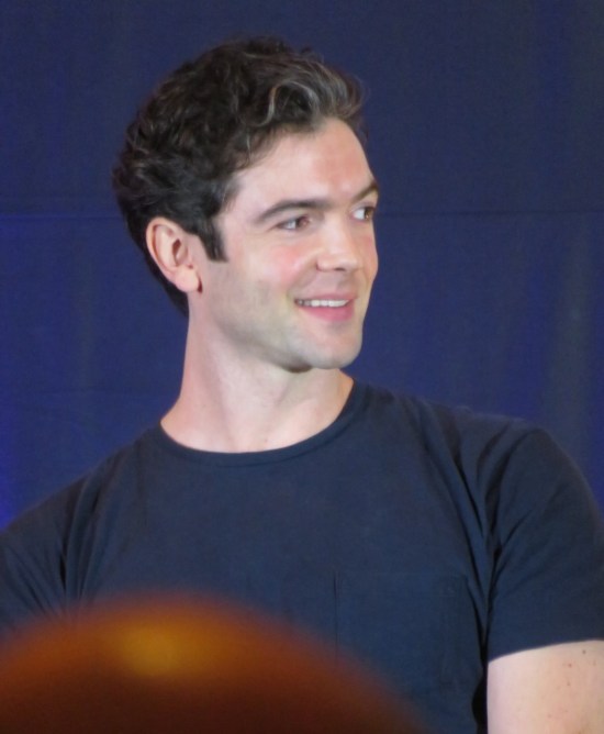 Ethan Peck smiling on stage.