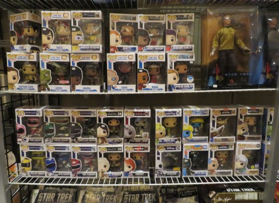 Two large shelves filled with Funko Pops. Half of them are Trek-themed.
