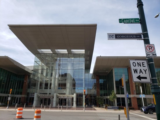 Gorgeous Drive sign in front of convention center two-story glass entrance.