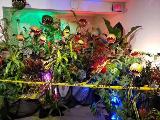 Museum display of very tall fake plants with teeth.