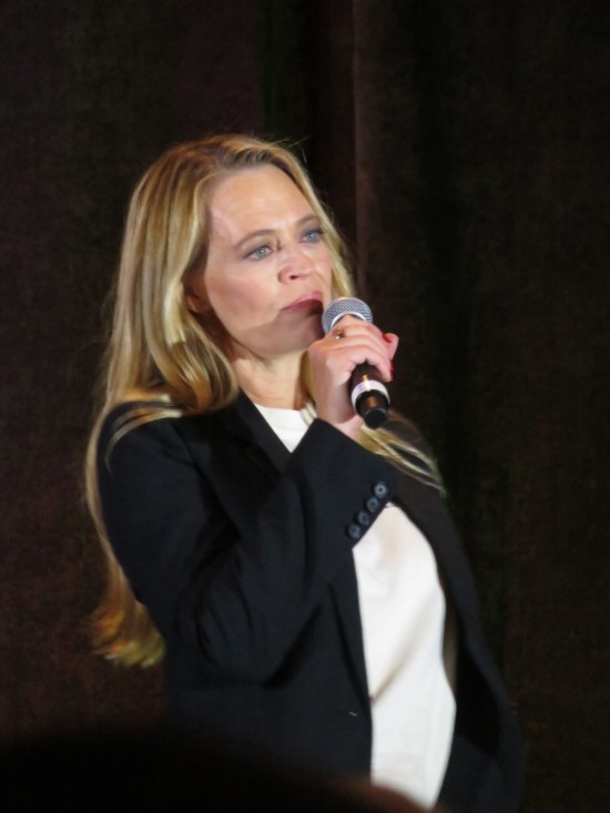 Jeri Ryan on stage, listening to a fan question.