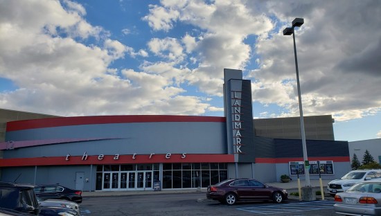 Gray and red theater with a vertical Landmark sign.