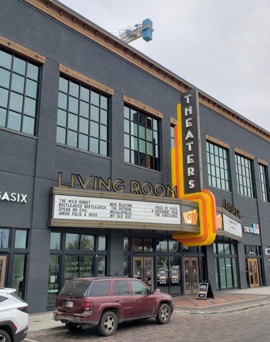 Living Room Theaters with marquee showing "Megalopolis", the "Joker" sequel, and other recent films.