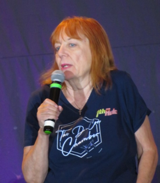 Lolita Fatjo with mic and a D-Con Chamber shirt.