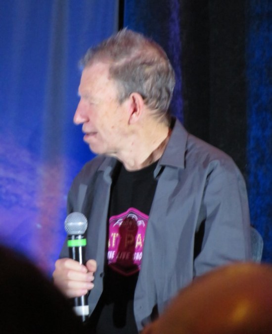 Max Grodenchik listening onstage.