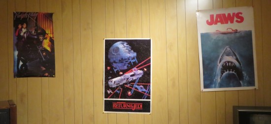 Posters of the movies "Purple Rain", Return of the Jedi", and "Jaws".