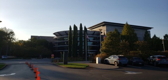 Fancy Indianapolis museum with large rotunda at the front and various evergreens.