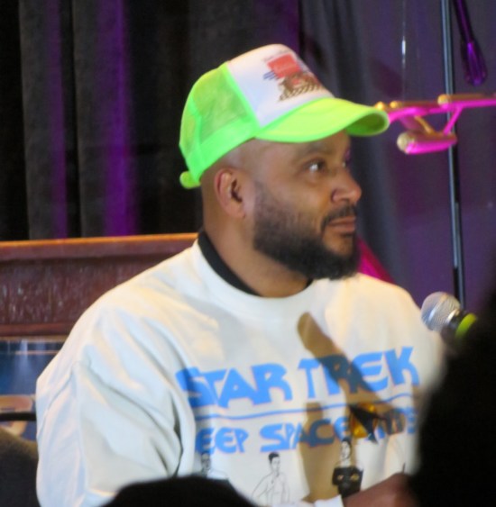 Cirroc Lofton in green ball cap and DS9 sweatshirt.