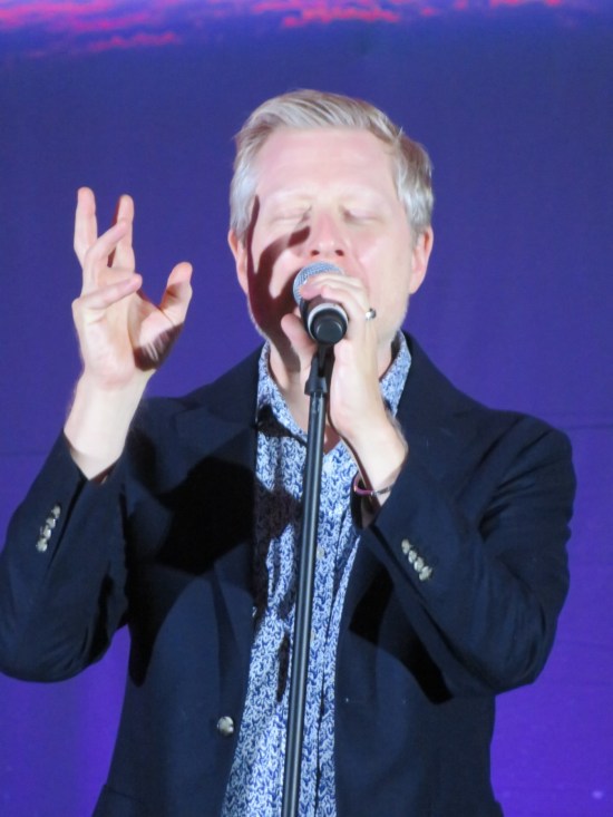 Anthony Rapp passionately singing.