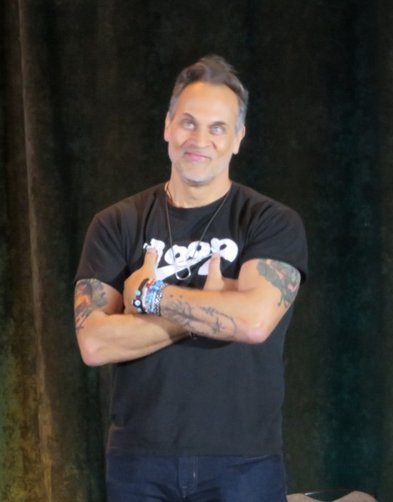 Todd Stashwick standing with arms folded, tattoos at the ready.