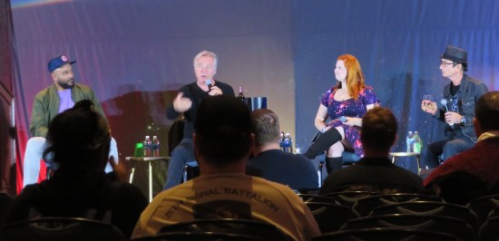 The four aforementioned actors on stage with slightly filled wine glasses.