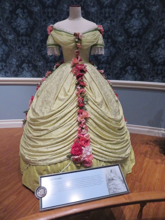 Light green ballroom dress with a long string of roses down the front. Short sleeves with laced cuffs, and roses as epaulets.