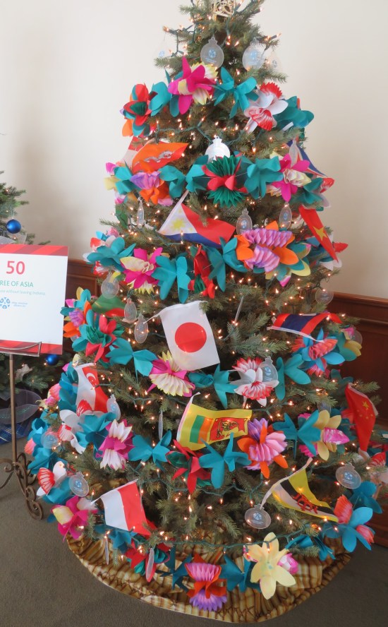 Christmas tree decorated with lts of blue and orange, plus a flag of Japan.