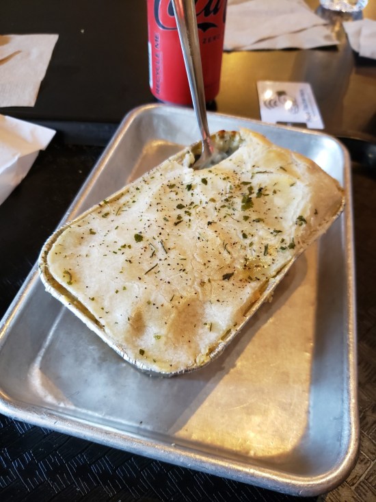 Rectangular chicken pot pie in a pan on a metal tray just big enough to hold it.