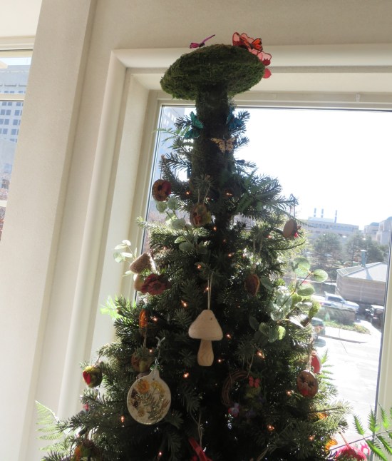 Christmas tree decorated with mushrooms. Topper is a great big moss-covered mushroom.