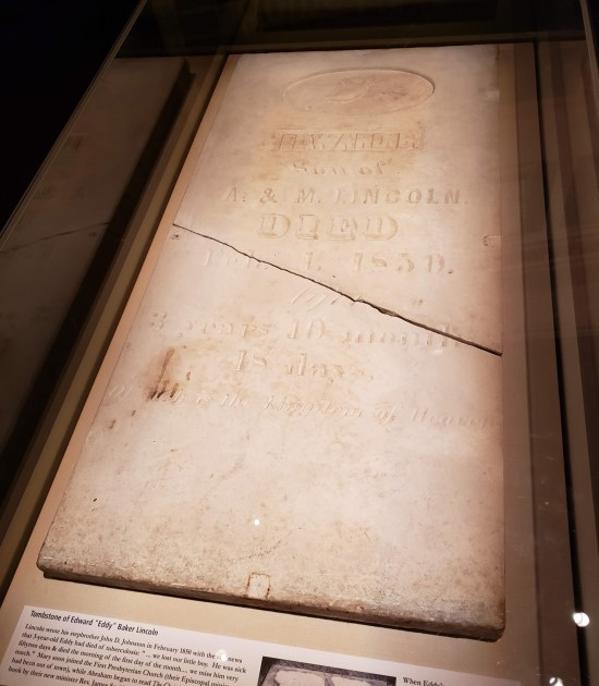 1850 tombstone for Eddy Baker Lincoln, a six-foot stone rectangle cracked in half.