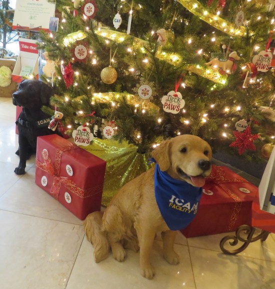 Stuffed dogs under a Christmas tree.