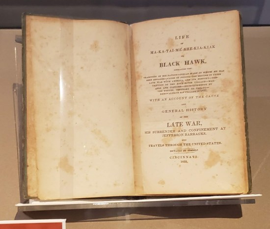 A vintage copy of "Life of Black Hawk" open to the title page.