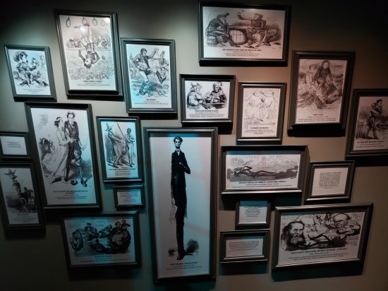 Wall covered by dozens of framed Lincoln caricatures.