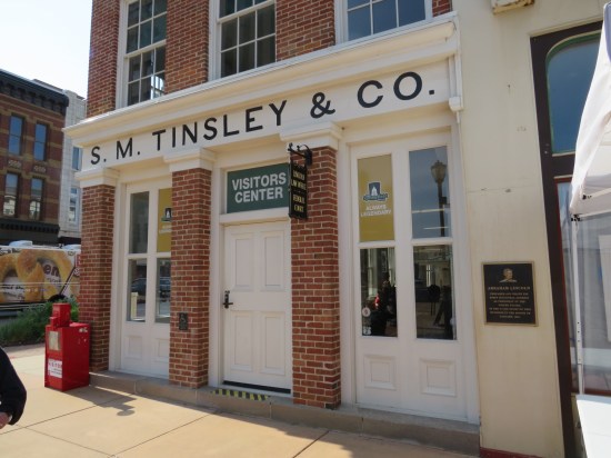 Lincoln Law Office Visitors Center is red brick, white-trimmed windows. Sign above front door says S.M. Tinsley & Co.