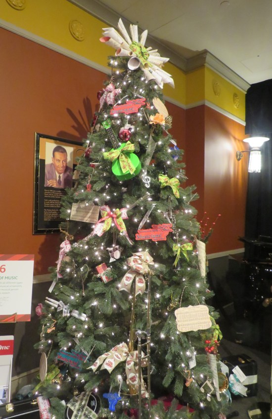 Christmas tree decorated with toy violin, pan pipes, an entire trombone, and so on.