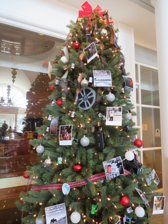 Christmas tree decorated with photos, cameras, and faux film.