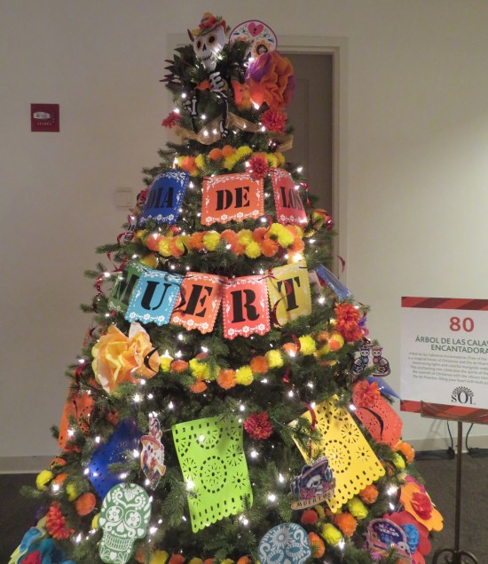 Dia de los Muertos treetop with skeleton, holiday name strand, and everything resembling Pixar's "Coco"