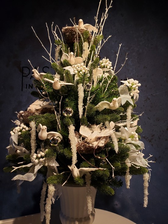 Tiny Christmas tree with handcrafted dove ornaments.