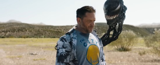 Tom Hardy walking in a desert with a CGI balloon tethered to his back. The balloon had scary teeth and Spider-Man eyes.
