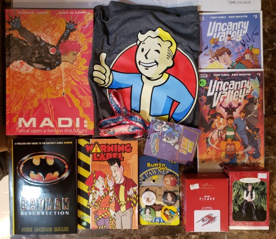 Lots of stuff we bought, including books, two Trek ornaments, and a Fallout shirt.