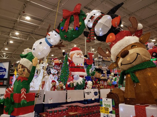 Store packed with large Christmas lawn decorations, including a giant Christmas arch.